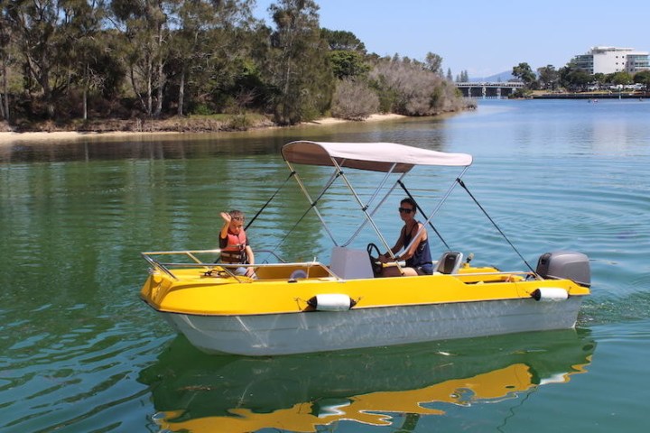 a small yellow boat on a body of water